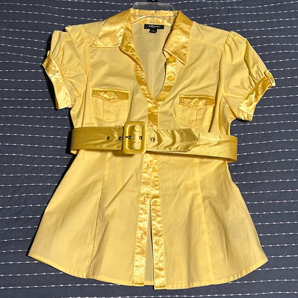 Light yellow button up blouse with satiny accents and belt. Fitted waist.